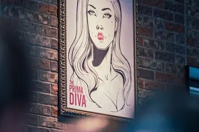 Framed commissioned artwork hung on a finished wall