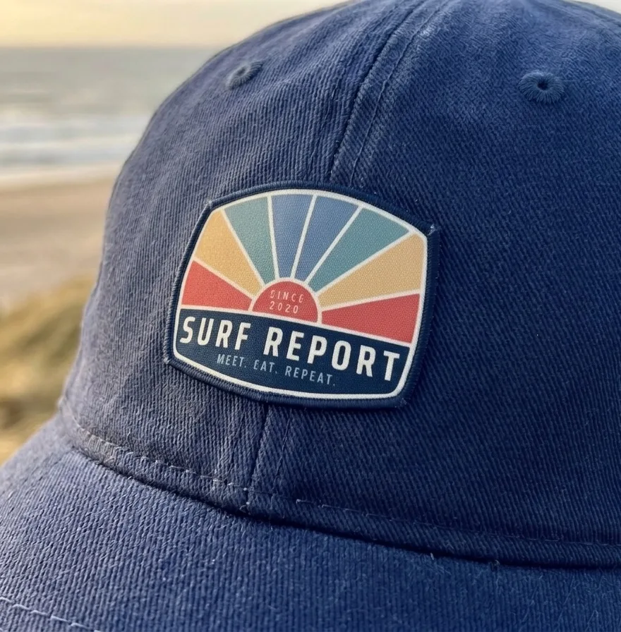 Surf Report logo on a woven patch on a trucker hat